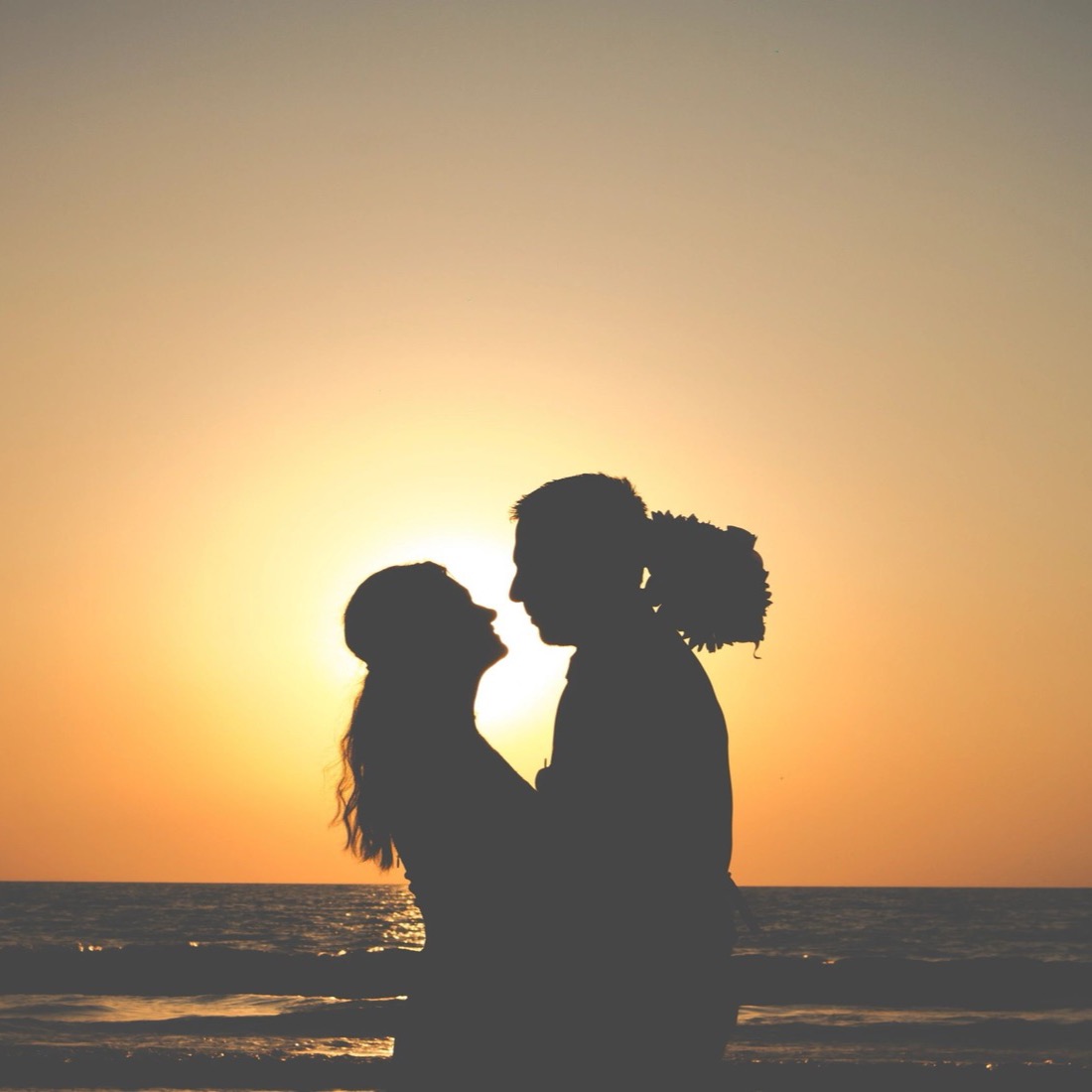 Silhouette of a couple against the sunset on the beach