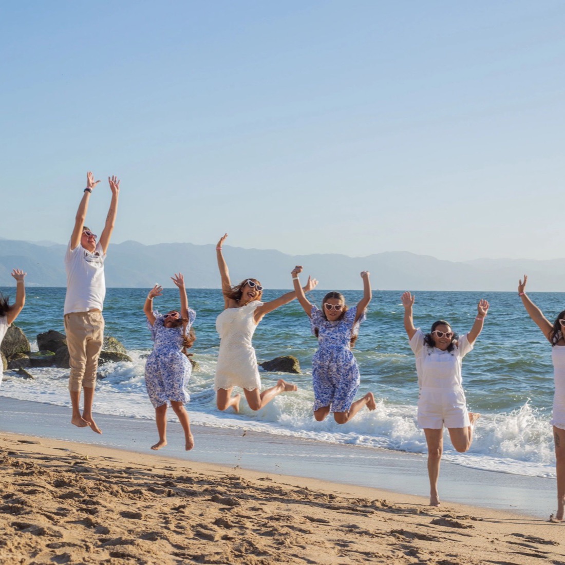 Family jumping for joy on the beach